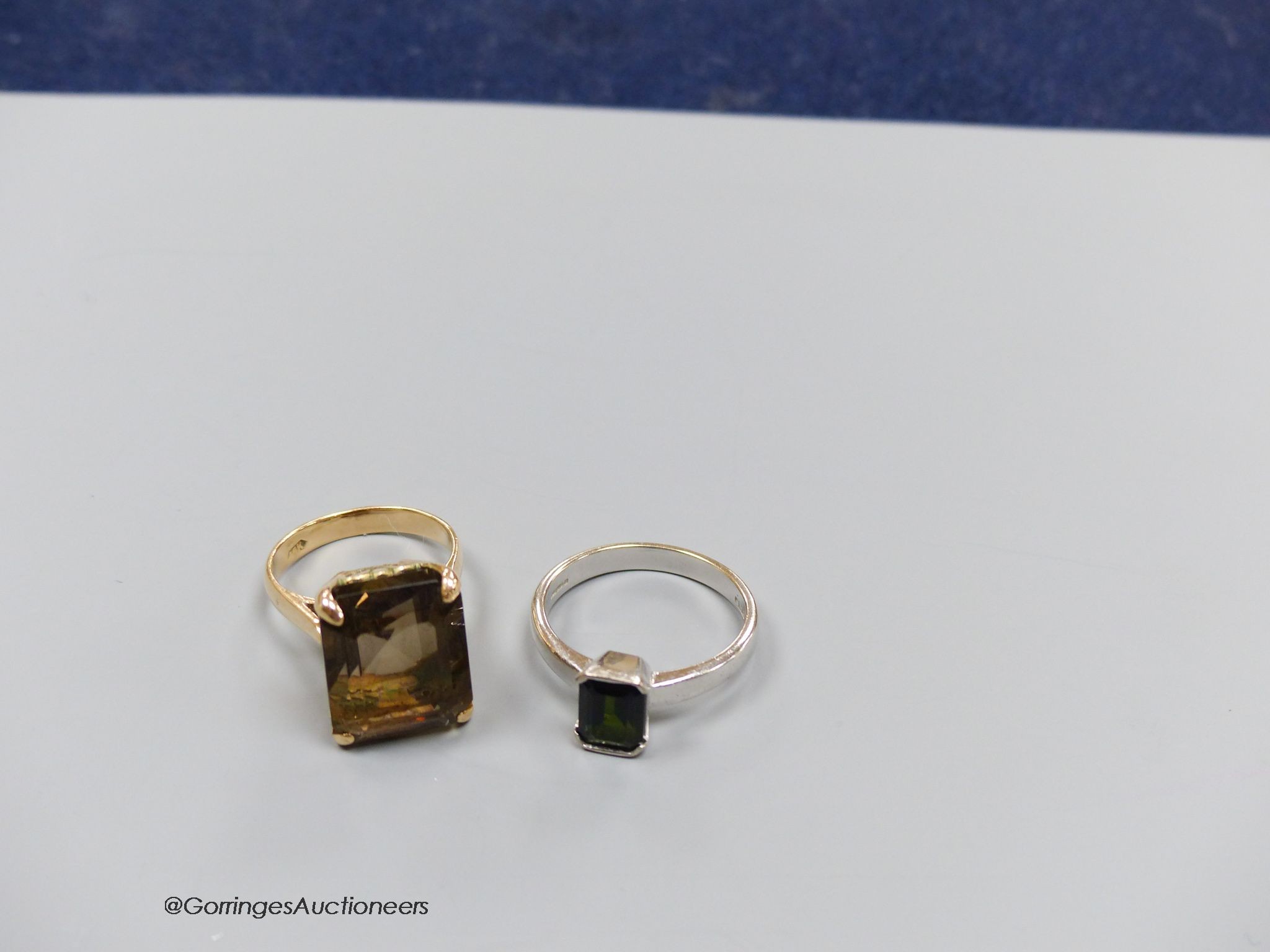 An 18ct white gold and tourmaline ring, size Q, gross 5g, and a 14k gold and smoky quartz ring, size M, gross 7g.